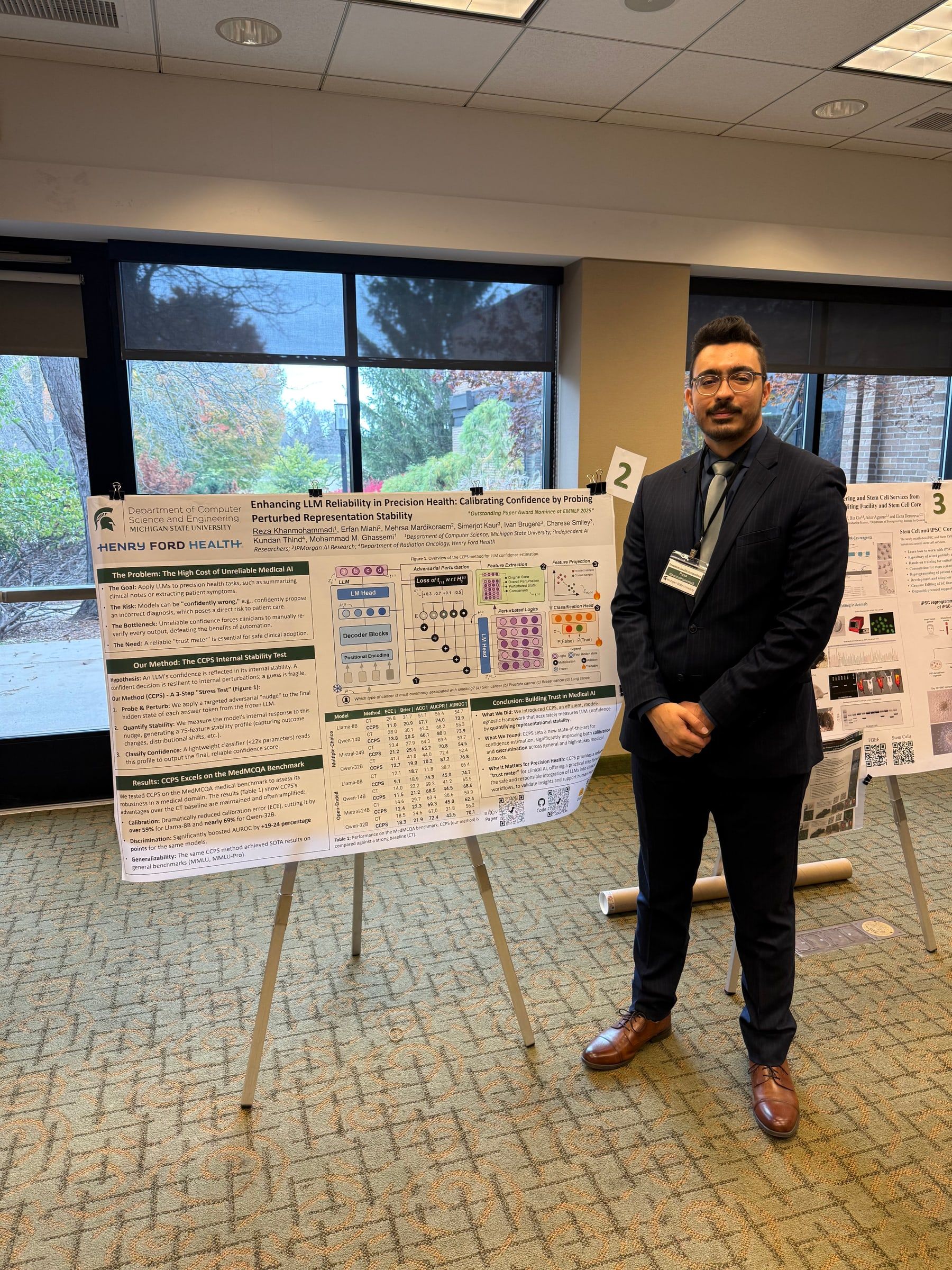 Reza standing beside an easel poster titled “Enhancing LLM Reliability in Precision Health”.